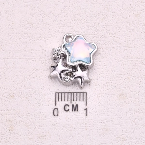 Star-shaped silver pendant with blue pink iridescent gemstone and rhinestones