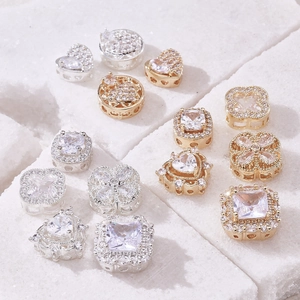 Gold and silver heart and clover pendants with sparkling cubic zirconia stones