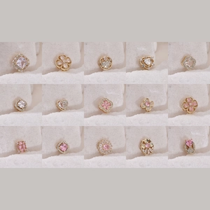 Selection of 15 gold plated jewelry charms with clover and heart zircon designs