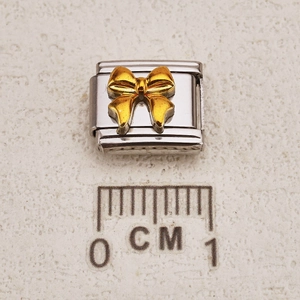 Italian modular bow shell charm in gold and silver finish with scale reference