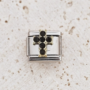 Close-up of Italian charm with gold cross and black crystal stones on steel base