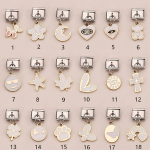 Italian charm link bracelet with assorted charms like clover and cross in gold and silver