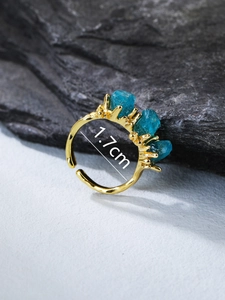 Macro view of blue apatite stones and 18K rose gold branch texture ring with 1.7cm diameter