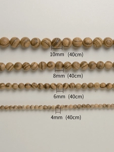 Detail of Vietnam Agarwood beads in 10mm, 8mm, 6mm, and 4mm sizes for DIY jewelry