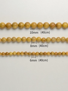 Gedetailleerde groottevergelijking van 6mm 8mm en 10mm gouden kamferhout ronde houten kralen