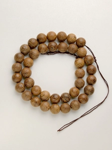 Detailed view of 8mm wenge wood Buddhist beads with natural tiger skin grain texture