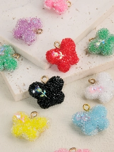 Détails macro de breloques papillon en résine givrée avec gravure de rose et anneaux