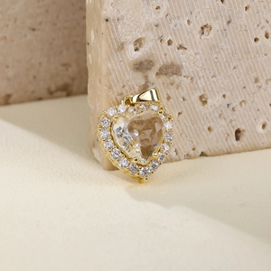 Elegant gold heart pendant necklace with micro-pave cubic zirconia on stone background