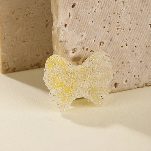Frosted resin bow bead for DIY jewelry making on natural stone background