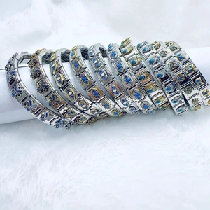 Vintage stainless steel modular link bracelet with blue enamel flower and gold crown charms
