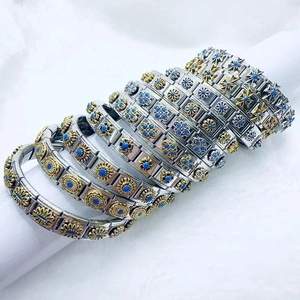 Vintage stainless steel modular bracelets with floral patterns and blue stones