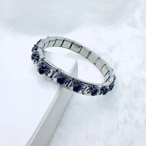 Macro shot of stainless steel gothic spider bracelet with black rhinestones details