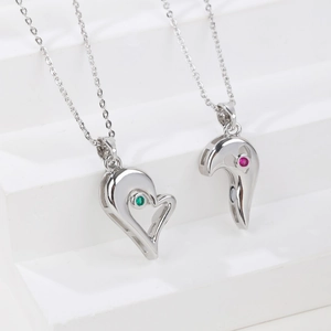 Matching heart pendant necklaces for couples with green and red inlaid gemstones
