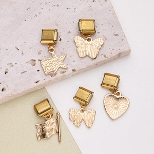 Italian modular gold charms in heart, star, and bow shapes on stainless steel base
