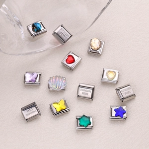 Macro detail of stainless steel charms with colorful resin stones for DIY bracelets