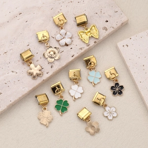 DIY stainless steel bracelet charms featuring floral, clover and butterfly pendants