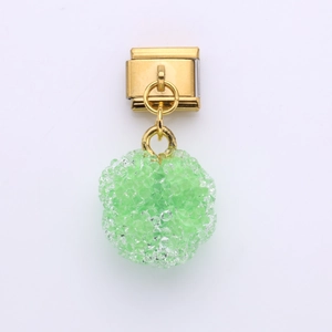 Close-up of green sugar-effect charm on golden stainless steel Italian link bracelet