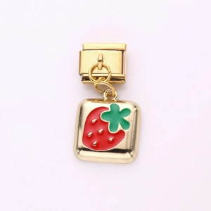 Detailed view of red enamel strawberry charm on a gold Italian modular bracelet link