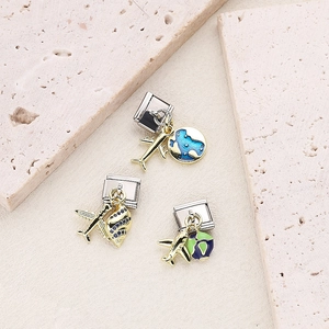 Macro detail of Italian modular charms featuring gold planes and enamel globe pendants