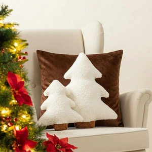 Detail of white plush teddy velvet Christmas tree pillows on a cozy sofa