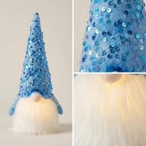 Detail showing glowing LED warm light through plush gnome beard and blue sequin hat