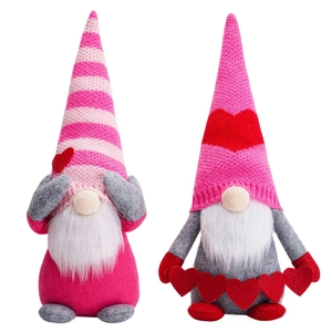 Pink and grey Valentine's Day gnomes with striped knit hats and heart decorations