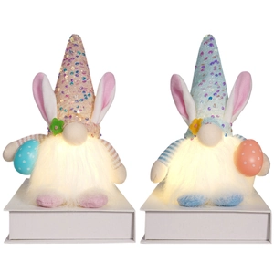 Light-up Easter bunny gnomes with sequin hats and eggs on a white display stand