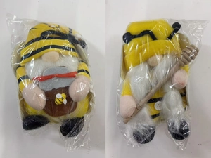 Detail showing two bee-themed gnomes plush with yellow stripes and honey jar accessories