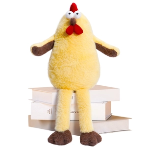 Cute yellow long-legged chick plush toy sitting on decorative books for home decor