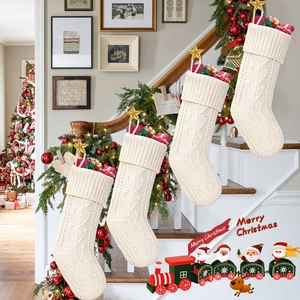 Detail of four cream knit Christmas stockings with cable patterns and gold star accents