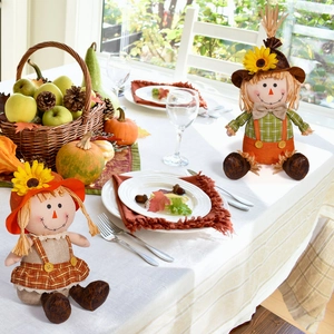 Detailed view of harvest festival scarecrow dolls with sunflowers on a rustic table setting