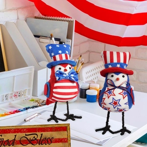 Detail view of two patriotic fabric bird figurines with American flag stars and stripes