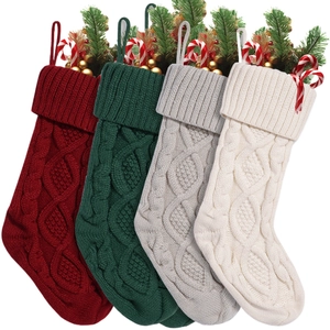 Set of four knitted Christmas stockings in wine red, green, grey, and cream colors