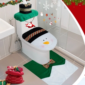 Close-up of snowman toilet cover set with red hat tank lid and green bathroom floor mat