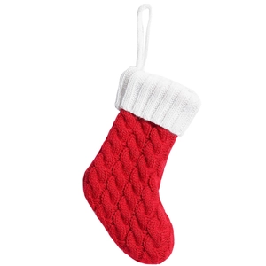 Classic red and white knitted Christmas stocking with cable pattern and white hanging loop