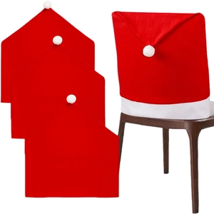 Set of 4 red Christmas Santa hat chair covers with white pom-poms for festive dining decor