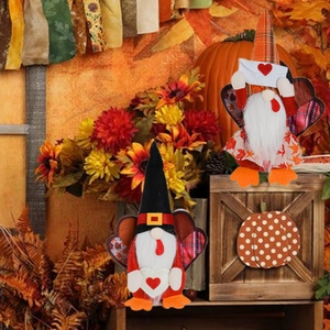 Detail of Thanksgiving gnomes with turkey wings and heart envelopes on autumn background