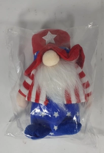Detail of USA Independence Day gnome plush in clear packaging showing stars and stripes decor