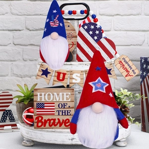 Close-up of USA patriotic gnomes and rustic wood ornaments on a white tiered tray