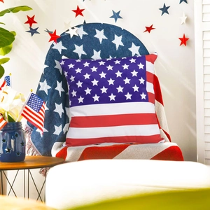 Detailed view of an Independence Day pillow with US flag pattern on a cozy chair