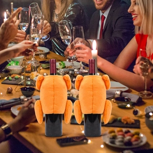 Close-up of two plush turkey wine bottle covers for festive Thanksgiving table decor