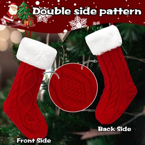 Knitted Christmas stockings with red cable pattern and white faux fur trim on a festive tree