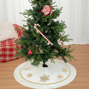 Ivory velvet Christmas tree skirt with gold foil snowflakes and sequin edge detail