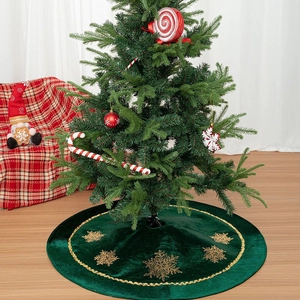 Green velvet Christmas tree skirt with golden snowflake embroidery and wavy gold trim