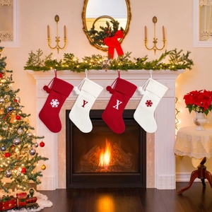 Detail of red and white knit Christmas stockings with snowflake patterns hung on a fireplace