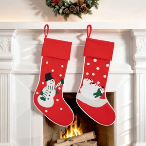 Close-up of snowman and polar bear Christmas stockings hanging by a warm fireplace