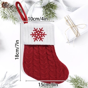 Knitted red Christmas stocking with snowflake embroidery and white cuff decoration