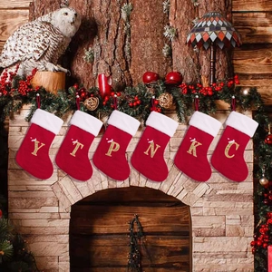 Classic red knitted Christmas stockings with white faux fur trim and gold glitter letters