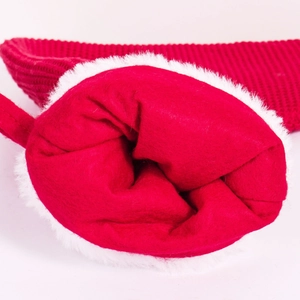 Detailed macro view of red knit fabric with plush white trim on Christmas accessory