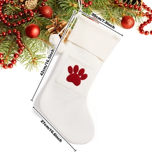 Detail of knitted Christmas stocking with red paw print and 42cm height dimensions